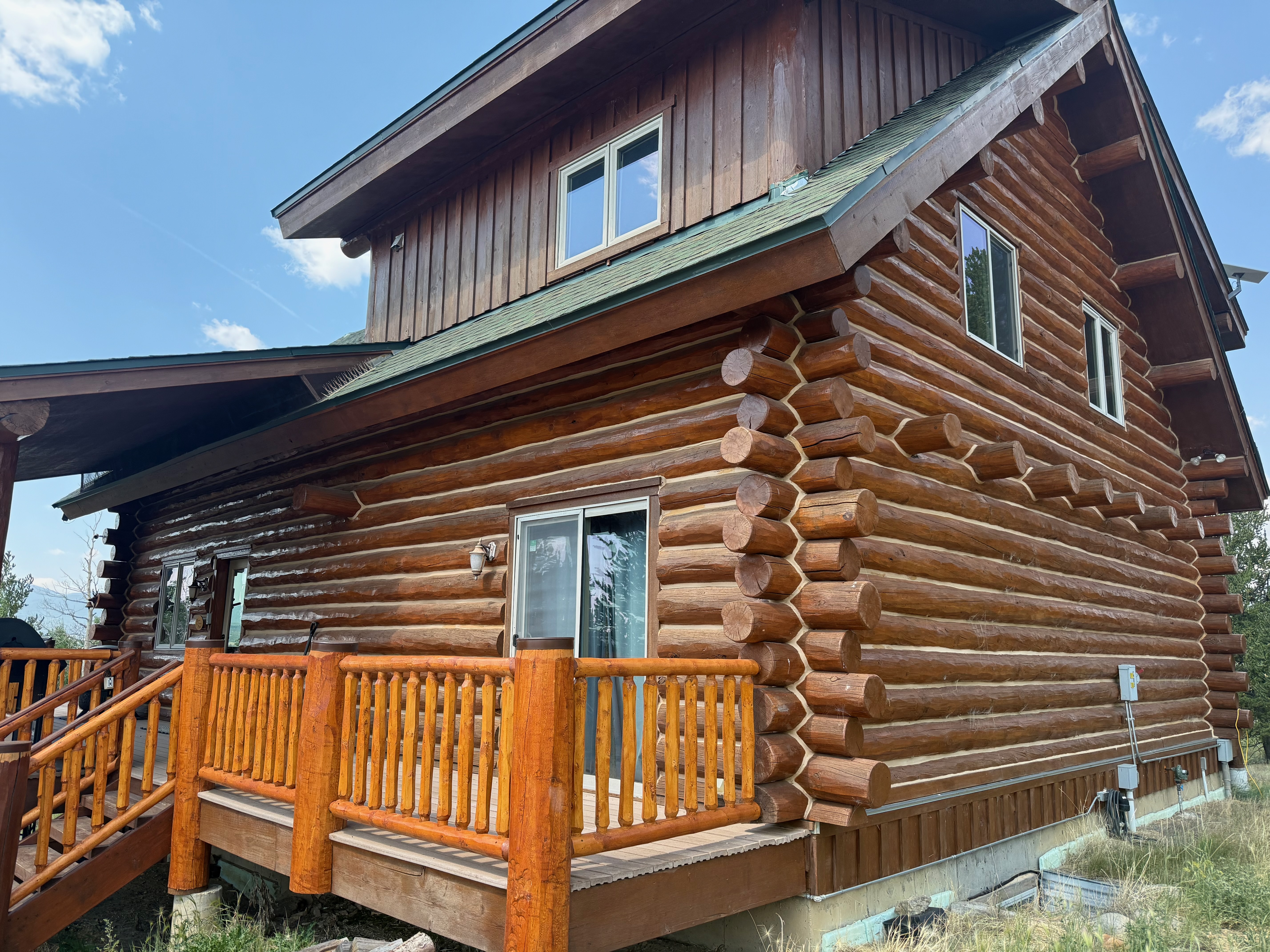 Ongoing maintenance work on log home exterior